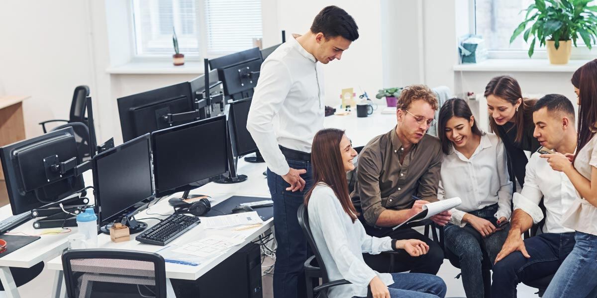 Group of coworkers huddled together at work