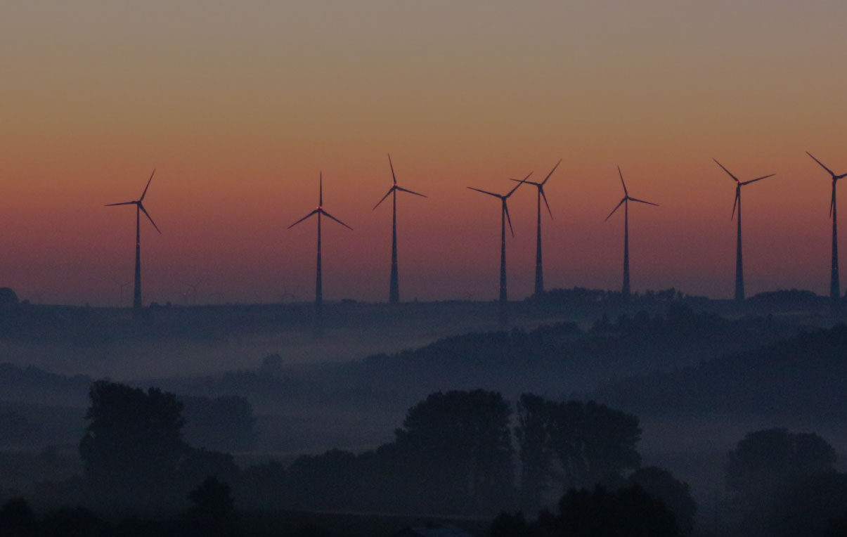 Wind turbines in the distance at sunrise